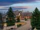 Stately home with a circular driveway, stone accents, and manicured landscaping in a serene setting at 1880 Mallard Dr, Broomfield, CO 80020