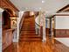 Elegant foyer featuring a wood staircase with decorative iron railing and stone accents at 1880 Mallard Dr, Broomfield, CO 80020
