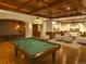 Game room with a pool table and ping pong table, plus a seating area with sofa and chairs at 1880 Mallard Dr, Broomfield, CO 80020