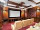 Home theater featuring tiered seating and wood paneling at 1880 Mallard Dr, Broomfield, CO 80020