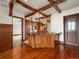 Open kitchen featuring wood cabinets, granite countertops, wood beam ceilings and wood floors at 1880 Mallard Dr, Broomfield, CO 80020