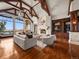 Spacious living room featuring fireplace, beamed ceilings, and large windows with views at 1880 Mallard Dr, Broomfield, CO 80020
