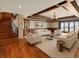 Open-concept living room featuring hardwood floors, coffered ceilings, and comfortable seating arrangements by the lake at 1880 Mallard Dr, Broomfield, CO 80020