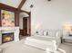 Bright main bedroom with a fireplace, white carpet, and minimalist decor creating a serene and restful space at 1880 Mallard Dr, Broomfield, CO 80020