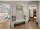 Hallway features a built-in mudroom bench with cabinets and an arched doorway into another room at 1880 Mallard Dr, Broomfield, CO 80020