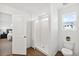 Clean bathroom featuring a shower with glass door, toilet, and view to the Primary bedroom at 22063 E 38Th Pl, Aurora, CO 80019
