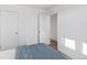 Bright bedroom featuring carpet, double door closet and access to upper floor at 22063 E 38Th Pl, Aurora, CO 80019
