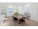 Bright dining room featuring a wooden table, black chairs, and natural light from multiple windows at 22063 E 38Th Pl, Aurora, CO 80019