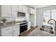 Modern kitchen features white cabinets, stainless steel appliances, and granite countertops, creating a clean and functional space at 22063 E 38Th Pl, Aurora, CO 80019