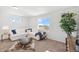 Bright living room with large windows, a comfortable sofa, and a modern touch with decorative accents and stylish furniture at 22063 E 38Th Pl, Aurora, CO 80019