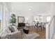 Bright living room featuring modern decor, hardwood floors, and open concept kitchen at 22063 E 38Th Pl, Aurora, CO 80019