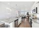 This open-concept living space has a modern kitchen that transitions to a dining space and cozy living room at 22063 E 38Th Pl, Aurora, CO 80019