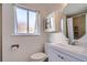 Bright bathroom featuring a modern vanity, lighting and round mirror at 7070 W 39Th Ave, Wheat Ridge, CO 80033