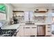 Contemporary kitchen with modern stainless appliances, white cabinets, and stylish open shelving at 7070 W 39Th Ave, Wheat Ridge, CO 80033