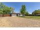 Large, private backyard featuring a brick house and mature trees at 8800 W Kentucky Ave, Lakewood, CO 80226