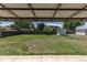 Large backyard features a covered patio, mature trees, and well maintained grass at 8800 W Kentucky Ave, Lakewood, CO 80226