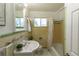 Bathroom featuring decorative green and yellow tile, white fixtures and bright light at 8800 W Kentucky Ave, Lakewood, CO 80226