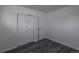 Bedroom with modern gray wood-look flooring, closet, and white painted walls at 8800 W Kentucky Ave, Lakewood, CO 80226