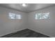 Bright bedroom featuring two windows and modern gray wood-look flooring at 8800 W Kentucky Ave, Lakewood, CO 80226