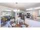 Open-concept dining area adjacent to the kitchen and living room, complete with modern fixtures and a welcoming ambiance at 8800 W Kentucky Ave, Lakewood, CO 80226