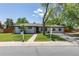 Charming single-story home with a well-manicured front yard and freshly painted white exterior, perfect for suburban living at 8800 W Kentucky Ave, Lakewood, CO 80226
