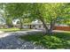 Lovely single-story home featuring mature trees and a spacious driveway at 8800 W Kentucky Ave, Lakewood, CO 80226