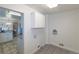 Clean laundry room with tiled floor and white cabinets for storage at 8800 W Kentucky Ave, Lakewood, CO 80226