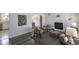 Sunlit living room with modern decor, stylish seating, fireplace and a seamless transition to the dining area at 8800 W Kentucky Ave, Lakewood, CO 80226