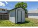 Storage shed in a private backyard features a white door and gray roof at 8800 W Kentucky Ave, Lakewood, CO 80226