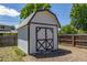 Outbuilding in backyard features barn-style doors and a gray roof at 8800 W Kentucky Ave, Lakewood, CO 80226