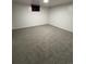 Finished basement with light gray carpeting and updated drywall at 14598 E Evans Ave, Aurora, CO 80014