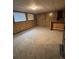 Spacious basement with wood paneling, carpet, and a small wet bar area at 14598 E Evans Ave, Aurora, CO 80014
