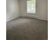 This bedroom has neutral carpeting and a window that provides natural light at 14598 E Evans Ave, Aurora, CO 80014