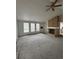 Spacious living room featuring carpet, a fireplace, and ample natural light at 14598 E Evans Ave, Aurora, CO 80014