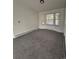 Bright, open living room with a large window at 14598 E Evans Ave, Aurora, CO 80014