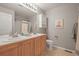 Bright bathroom with a double sink vanity and a shower-tub combination at 7065 Campden Pl, Castle Pines, CO 80108