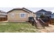 Backyard featuring a deck, stairs, and a well-maintained lawn, perfect for outdoor enjoyment at 3972 S Shawnee Way, Aurora, CO 80018