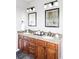 Elegant bathroom featuring granite countertops, dual sinks, and modern fixtures at 3972 S Shawnee Way, Aurora, CO 80018