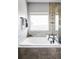 Luxurious bathroom featuring a deep soaking tub and a separate glass-enclosed shower at 3972 S Shawnee Way, Aurora, CO 80018
