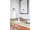 Bathroom featuring granite counters, dark wood cabinets, and modern fixtures at 3972 S Shawnee Way, Aurora, CO 80018