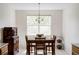 Bright dining room with a wooden table, chairs, and a charming chandelier at 3972 S Shawnee Way, Aurora, CO 80018