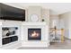 Close up of the fireplace in the living room, with a display shelf to the side, and the stairwell behind at 3972 S Shawnee Way, Aurora, CO 80018