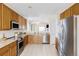 Well-lit kitchen featuring stainless steel appliances, tile flooring, and ample counter space for cooking and meal preparation at 3972 S Shawnee Way, Aurora, CO 80018