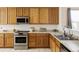 Well-equipped kitchen with modern appliances, warm cabinetry, and a functional layout perfect for cooking enthusiasts at 3972 S Shawnee Way, Aurora, CO 80018