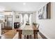 Bright dining room featuring a long wooden table, hardwood floors, and stylish decor at 1045 W 101St Ave, Northglenn, CO 80260