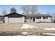 Charming single-story home with a white brick facade, black accents, and a well-manicured front yard at 1045 W 101St Ave, Northglenn, CO 80260