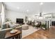 Open-concept living room with seamless transition to the modern kitchen at 1045 W 101St Ave, Northglenn, CO 80260