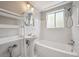 Bathroom featuring white tiles, pedestal sink and shower over tub at 1130 N Pennsylvania St # 208, Denver, CO 80203
