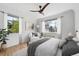 Relaxing bedroom filled with natural light from several windows, plush carpet, and modern ceiling fan at 1130 N Pennsylvania St # 208, Denver, CO 80203