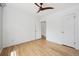 Spacious bedroom with hardwood floors, white walls, and a modern ceiling fan at 1130 N Pennsylvania St # 208, Denver, CO 80203
